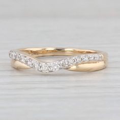 a yellow gold wedding band with white diamonds