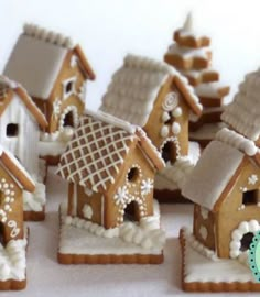 a group of gingerbread houses with snow on them