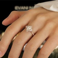 a woman's hand with a diamond ring on it