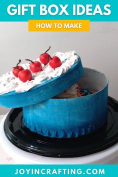 a blue cake with cherries on top and the words gift box ideas how to make