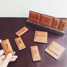 a person is playing with some cards and numbers on a table in front of them