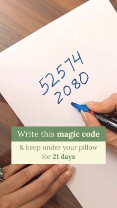 two hands writing on a piece of paper with the words write this magic code and keep under your pillow for 21 days