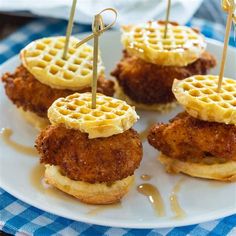 fried chicken and waffles on a plate with toothpicks in the middle