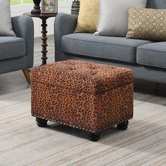 a living room with two couches and a leopard print ottoman