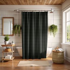 a bath room with a shower curtain and a rug on the floor in front of it