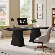 a desk with a chair and computer on it in front of a large window that has the number thirteen printed on it