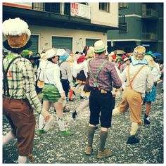 several people dressed in costume walking down the street