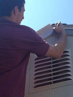 a man is working on an air conditioner