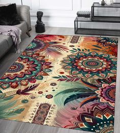 a colorful area rug with flowers and feathers on the floor in front of a couch