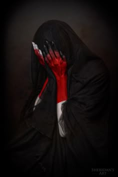 a woman with her hands painted red and black