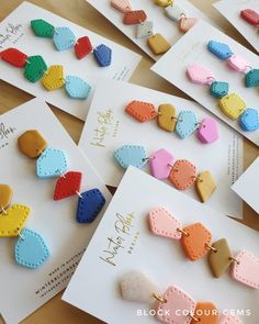 many different types of earrings are displayed on cards