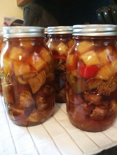 three jars filled with food sitting on top of a table