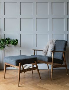 a chair and ottoman in front of a white wall