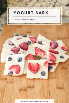 yogurt bark with strawberries and blueberries in it on a cutting board