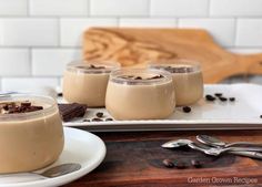 three glasses of chocolate pudding on a plate