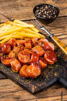 hot dogs and french fries on a cutting board