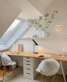 an attic bedroom with a desk and chair