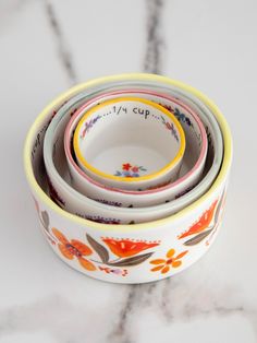 three colorful bowls are stacked next to each other on a marble countertop, with the words my cup written in cursive writing