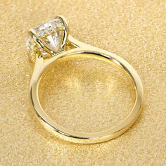 a yellow gold ring with a diamond on it