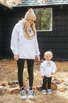 I'm a Cool Mom checkered smiley face trendy hoodie for moms. This white mom hoodie is super cozy and pairs perfectly with our Cool Dad, Cool Kid & Cool Baby matching hoodies & a onesie for the whole family! Shop the full Krista Horton x Slyfox collection for more trendy mom sweatshirts, matching family sweatshirts & everything you need to achieve the ultimate cool mom aesthetic. For Sizing Reference: Krista is wearing a sx XL Cool Mom Aesthetic, Young Mom Outfits, Young Mom Style, Checkered Smiley Face, Son Outfits, Family Sweatshirts