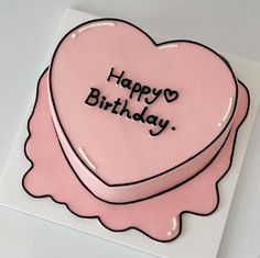 a pink heart shaped cake with the words happy birthday written on it's side