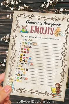 a child's storybook emojis is held up in front of flowers