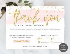 a pink and gold thank you card with white flowers on the table next to it