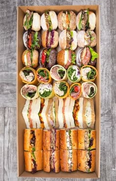 a box filled with lots of different types of sandwiches