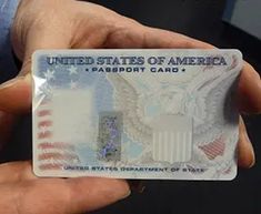 a person holding an american passport card in their left hand with the united states of america stamp on it