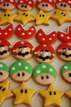 decorated cookies are arranged in the shape of mario's head and star shaped stars