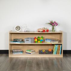 a wooden shelf filled with books and toys