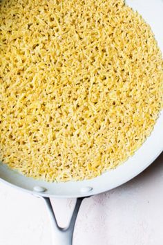 a pan filled with rice sitting on top of a table