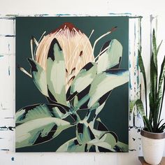 a painting on a wall with plants in the foreground and a potted plant next to it