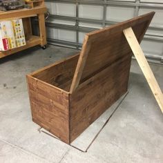 a wooden box sitting in front of a garage door