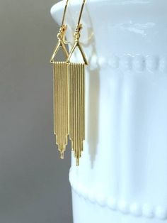 Textured Front, Hollow Back It doesn't get any simpler than these classic everyday Art Deco style earrings. The design is sleek, modern, and timeless. The earrings feature textured stylized waterfall gold plated stamped brass pendants. PLEASE NOTE: These earrings are hollow on the reverse side. (SEE 2nd PHOTO) Simple yet stunning; and light as a feather (lobe friendly) yet sturdy. Perfect everyday, every occasion earrings that you will reach for again and again. The earrings measure about 2 1/4 Art Deco Dangle Brass Earrings, Nickel-free Dangle Earrings In Art Deco Style, Nickel-free Dangle Art Deco Earrings, Nickel-free Art Deco Dangle Earrings, Art Deco Gold Dangle Earrings, Vintage Gold Long Drop Earrings, Handmade Art Deco Gold Earrings, Handmade Art Deco Dangle Earrings, Adjustable Antique Gold Earrings