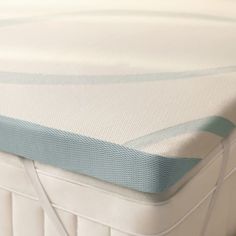 a close up view of the top of a mattress that is made with blue and white stripes