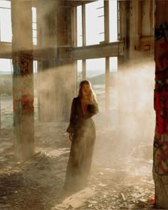 a woman standing in an abandoned building with steam coming out of the floor and walls