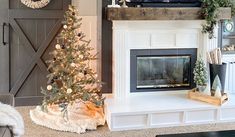 a living room with a christmas tree and fireplace