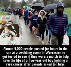 a group of people walking down a street with umbrellas over their heads and one person holding an infant