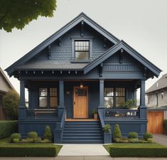 a blue house with two front porches and steps leading up to the entrance door