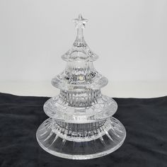 a clear glass christmas tree on a black table