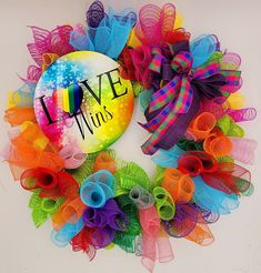 a colorful wreath with the words live, love, and rainbows written on it