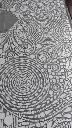 an intricately designed floor is shown in black and white, with circles on it