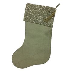 a green christmas stocking with silver sequins and a tassel on top