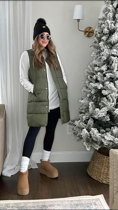 My fav is this long hunter green puffer vest! Paired with mt white long-sleeve tunic and leggings. Witner outfit, elevated casual outfit, outfit inspo, neutral style. #winteroutfit #winterstyle #puffervest #longpuffervest #winterstyle #casualwinteroutfit #elevatedoutfit Long Vest Puffer Outfit Ideas, Leggings Puffer Vest Outfit, Outfits With Long Puffer Vests, Sweatsuit With Puffer Vest, Puffer Vest Outfits For Women Winter, Green Puffer Vest Outfits For Women, Long Vest Outfits For Women Casual, Green Vest Outfit Fall, Long Puffer Vest Outfits For Women