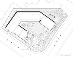 an aerial view of a building with plans for the ground and parking spaces on each side