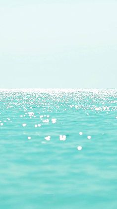 a person riding a surfboard on top of a body of water in the ocean