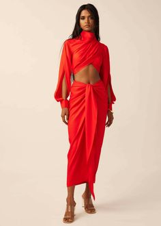 Make a bold statement with our scarlet crop top. This striking crop top in vibrant red tencel features a high pleated neck and long slit sleeves, exuding an air of sophistication and glamour. The pleated detail adds texture and visual interest, while the crop length allows for effortless pairing with high-waisted bottoms. With its contemporary design and captivating color, this crop top is a true embodiment of modern elegance and feminine allure. Futuristic Outfits Women, Formal Crop Top, Co Ords Outfits, Pleated Neck, 2024 Dresses, Dramatic Sleeves, Concert Looks, Knitwear Fashion, Crop Top Outfits