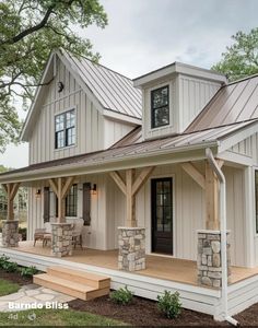 a white house with a porch and stone pillars