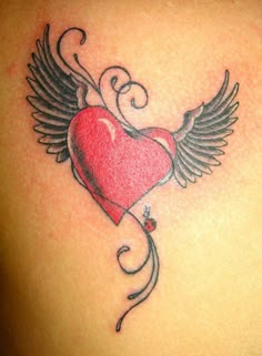 an image of a heart with wings on the back of a woman's shoulder